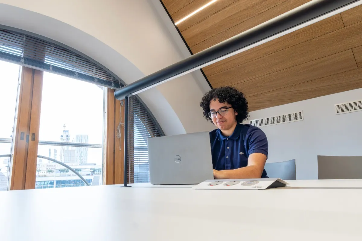 A student working in front of a laptop at Leeds City Campus.