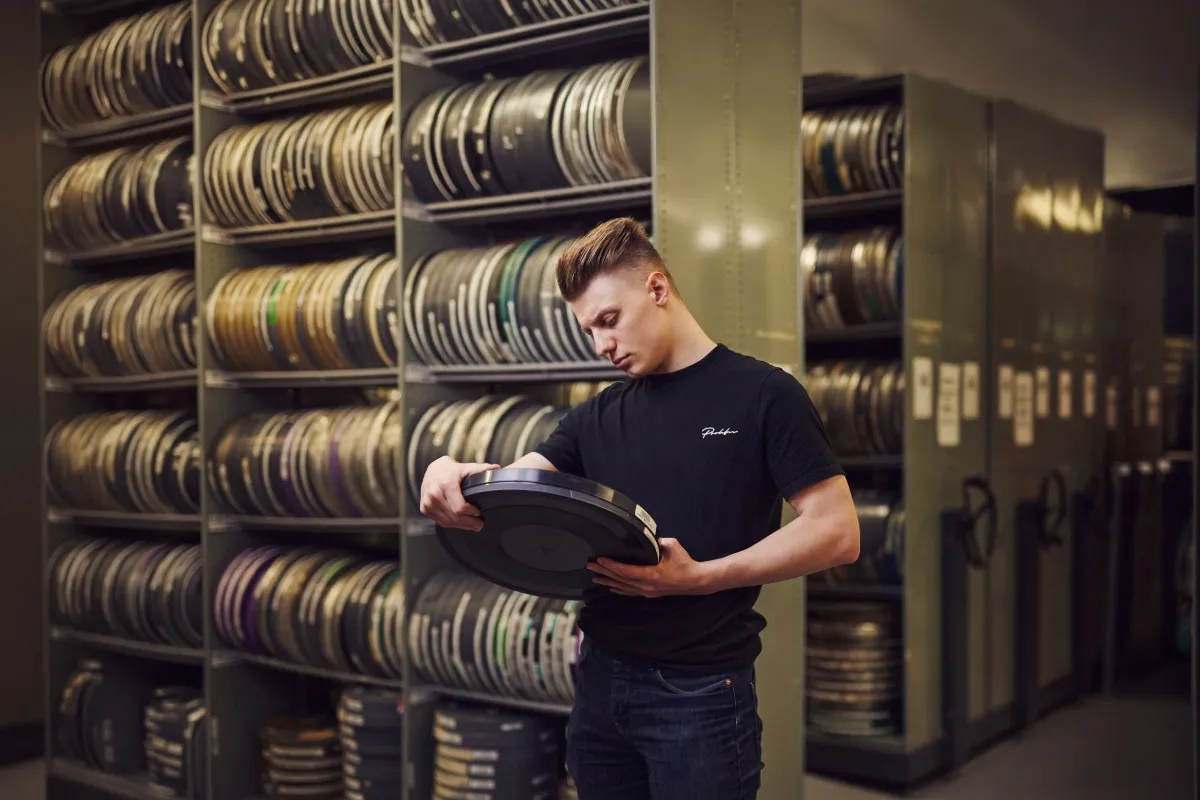 Film student using camera equipment.
