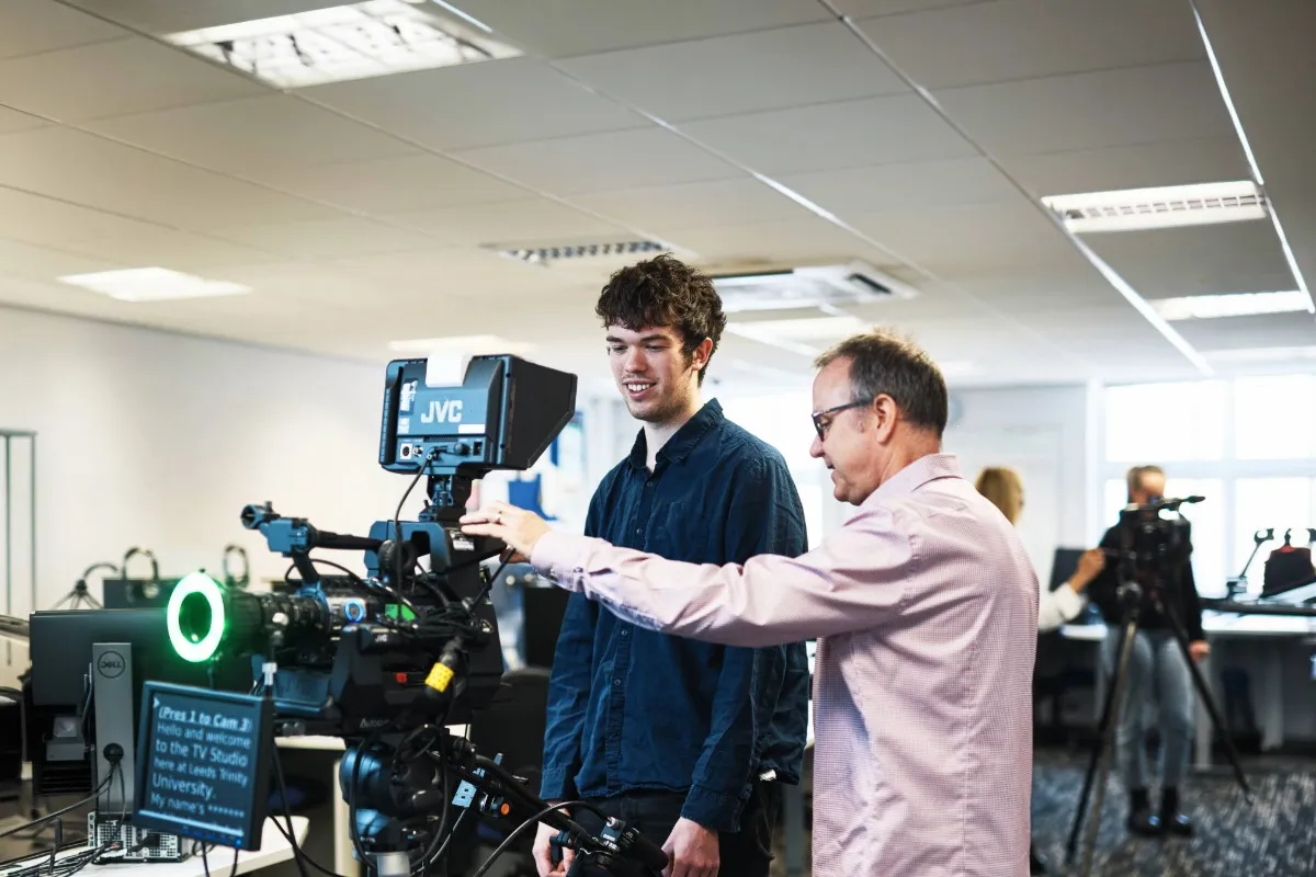Film student and Media Staff member using camera equipment.