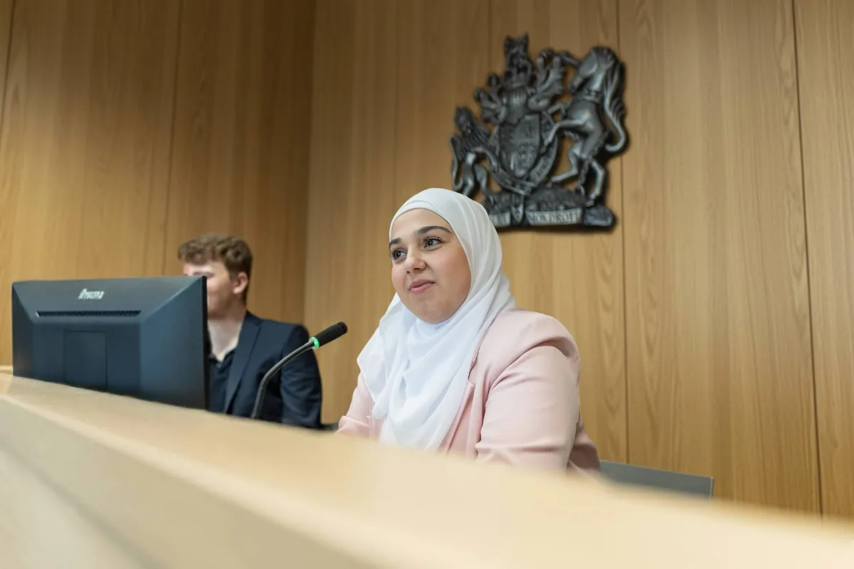 Law students practising in the moot court room at Leeds City Campus.