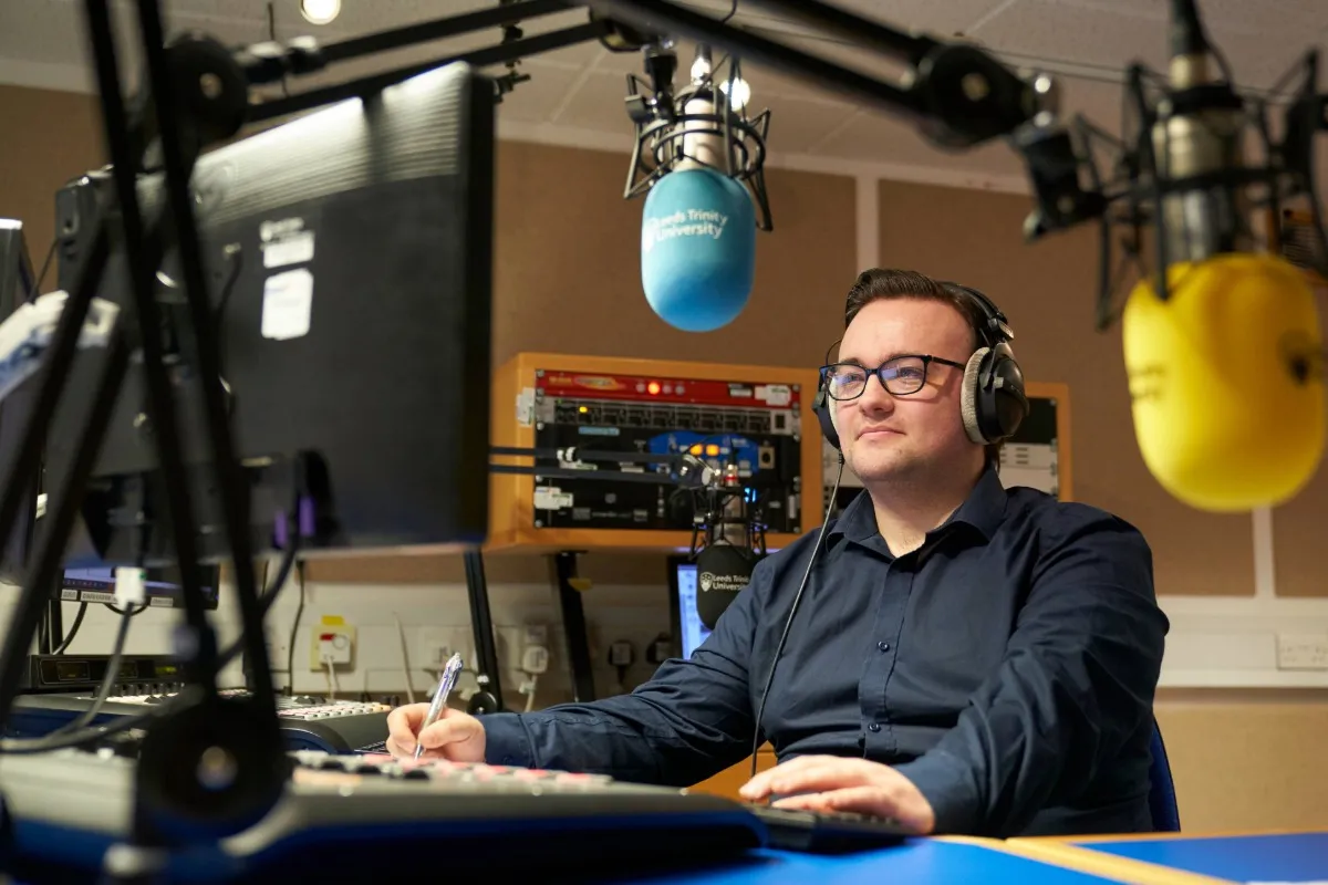 Sports Journalism student working in the radio studio at Main Campus.