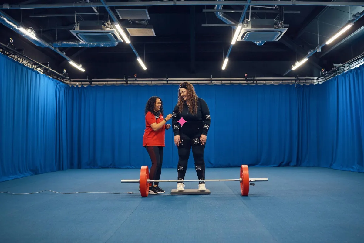 Two students working in our Sports hall at our Main Campus.