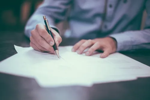 Man writing on paper .