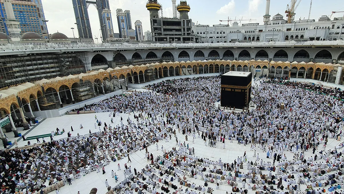 A wide shot of people dressed in white observing Hajj at Mecca.