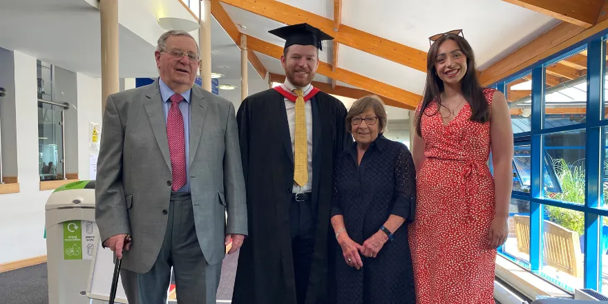 Student celebrating graduation with his family.