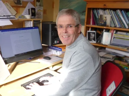 John sitting at the computer .