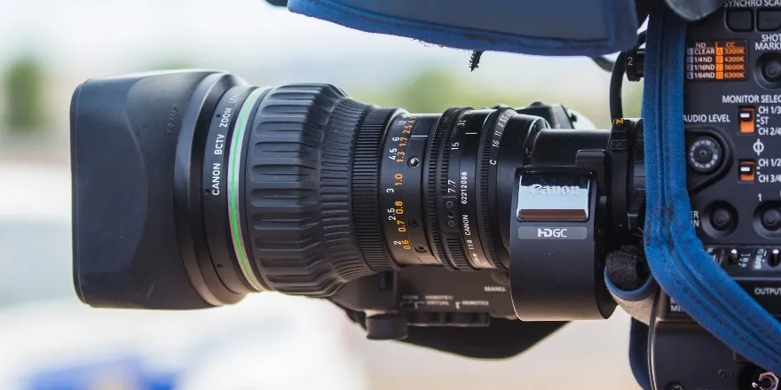Black Canon camera with zoom lens.
