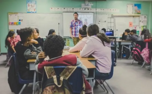 Classroom setting with students and teacher .