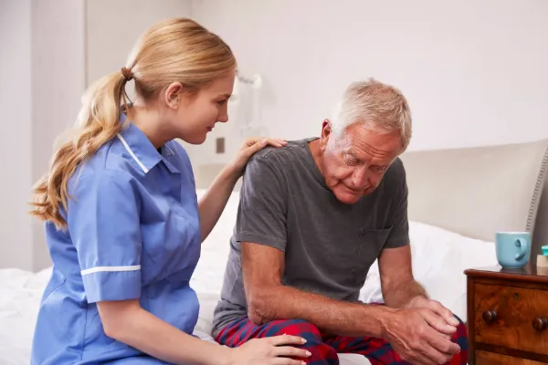 Health care professional helping a patient.