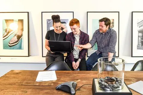 Student being shown work on placement by colleagues.