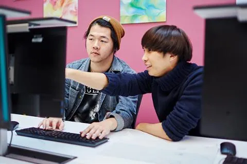 Students learning in library facility teaching space.
