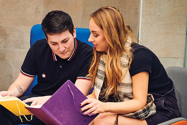 Two students going over notes from class.
