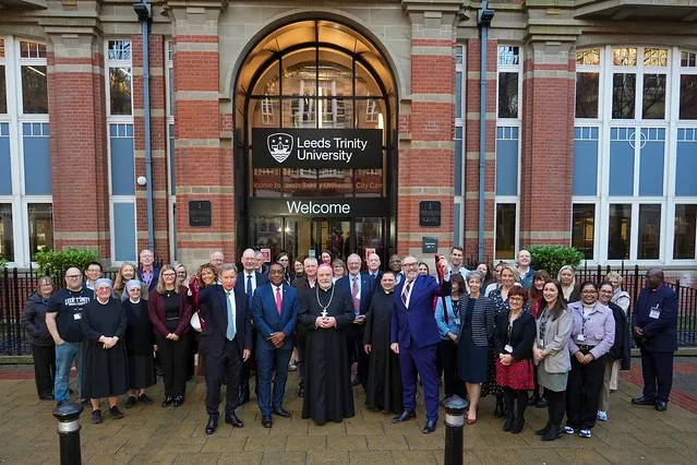 Group photograph of Leeds Trinity staff and the Bishop of Leeds.