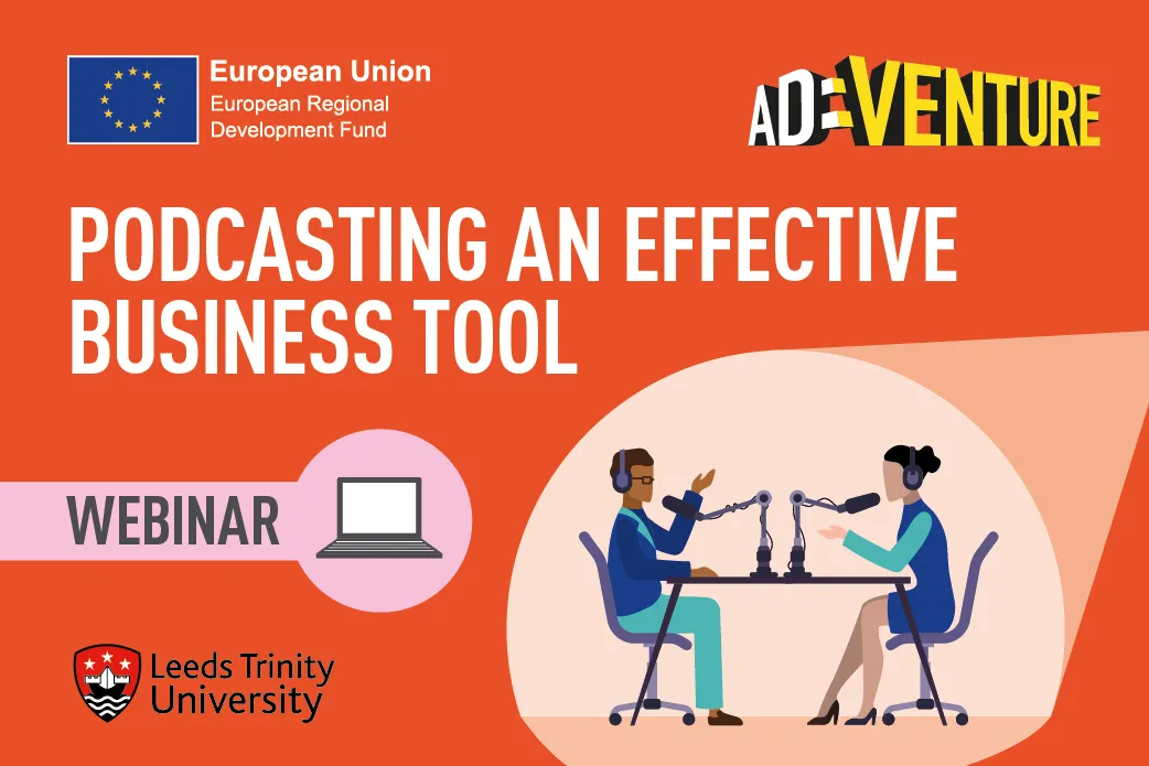 Two people in a recording studio with microphones at a table. .