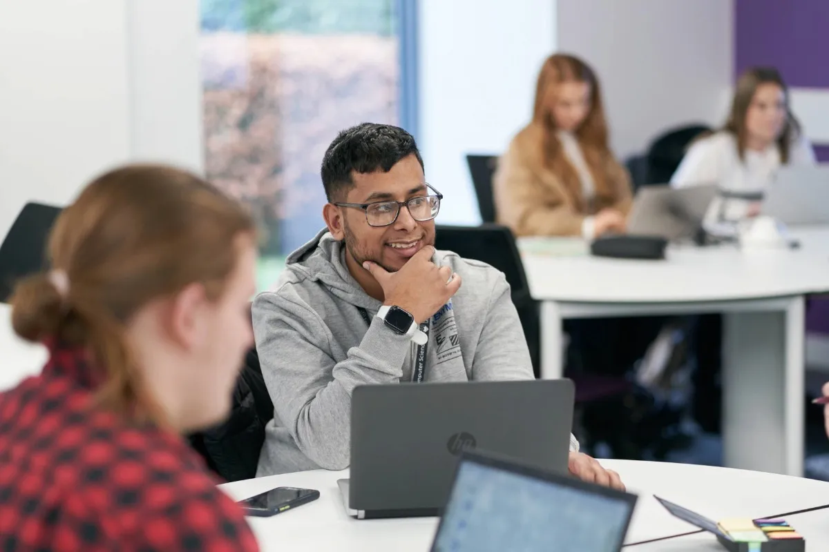 Students in a seminar working on their laptops.