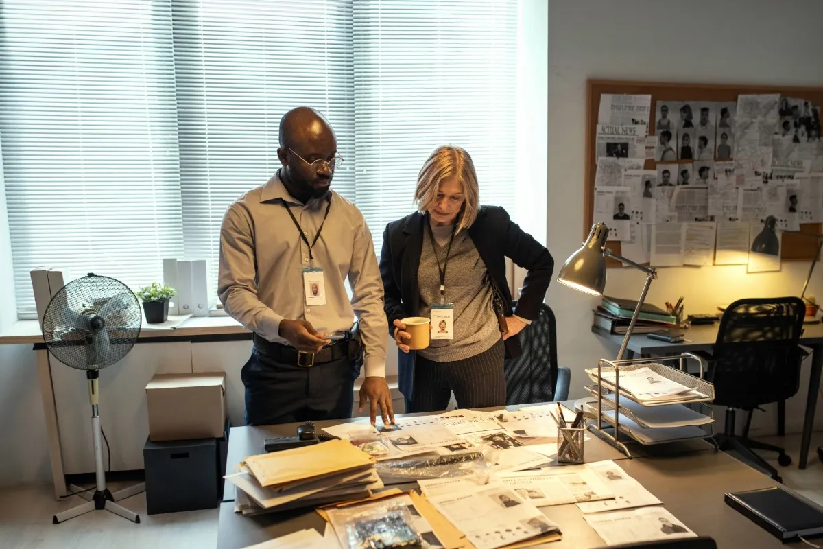 Two adults review case notes.