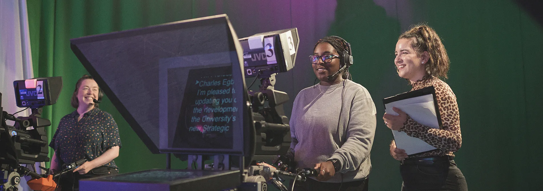 Two Digital and Screen Media students control a camera rig in the Media Centre