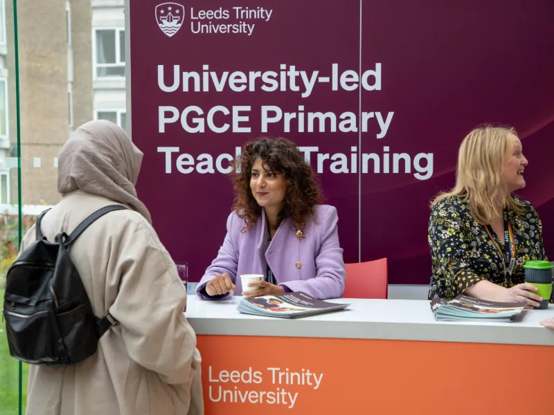 PGCE academic talking to a prospective student at a Leeds Trinity PGCE Open Day