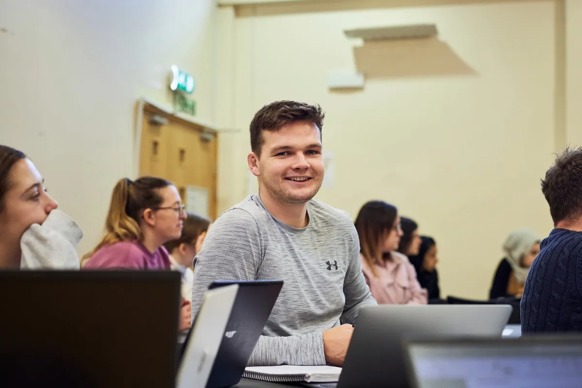 Student smiling in class.