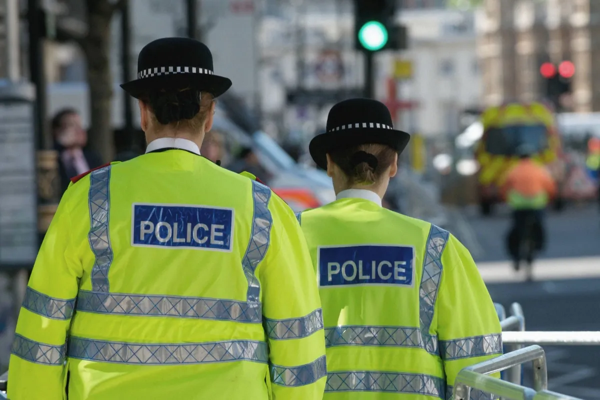 Police officers walking down a street.