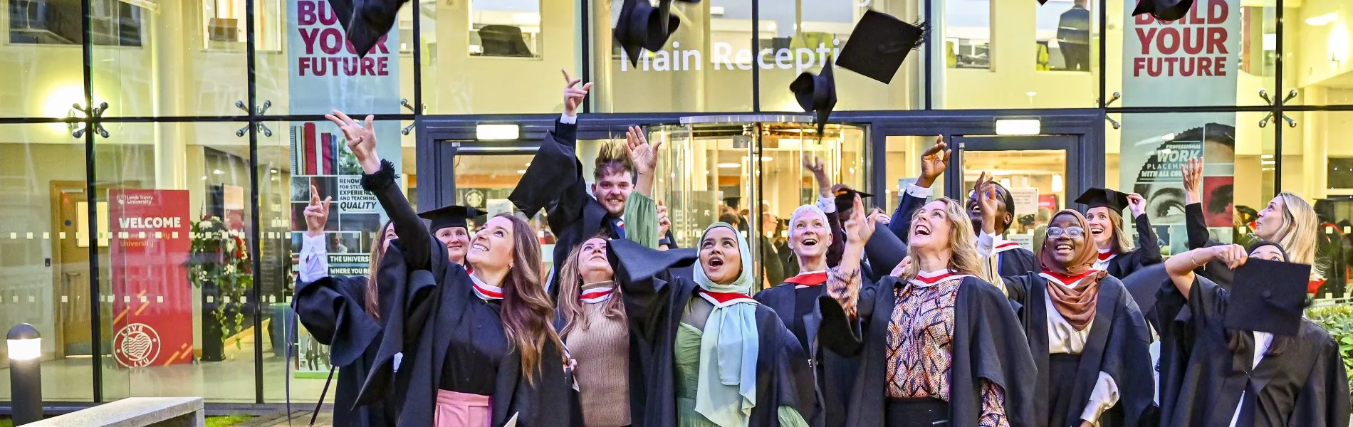 A group of graduates throwing their mortar boards in the air