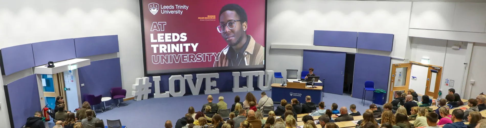 Guests listening to Leeds Trinity welcome talk at an Open Day