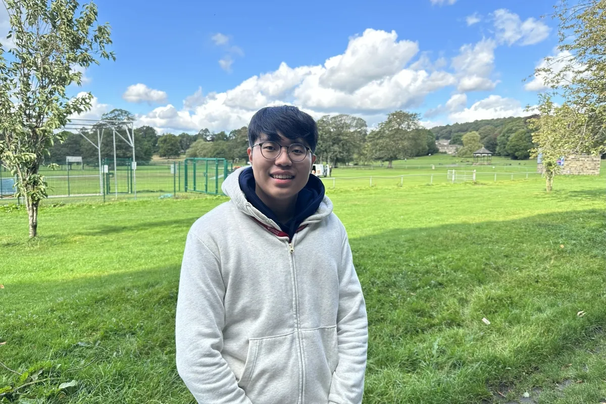 Incoming Exchange student stood in a park..