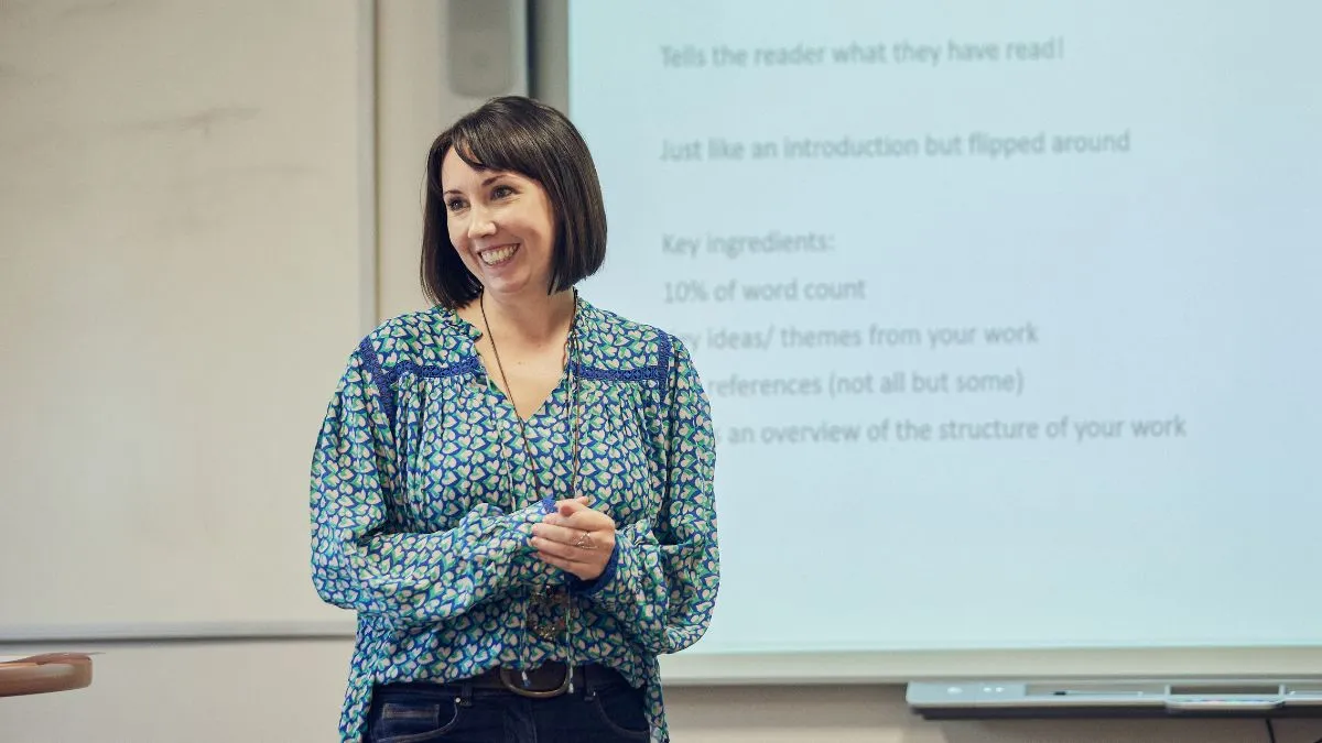 A picture of a lecturer smiling.