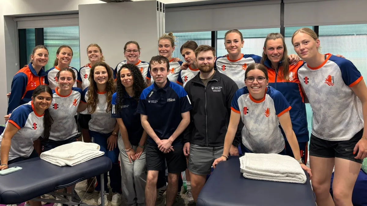 The Dutch women cricket team with two Leeds Trinity University students in a conditioning suite..