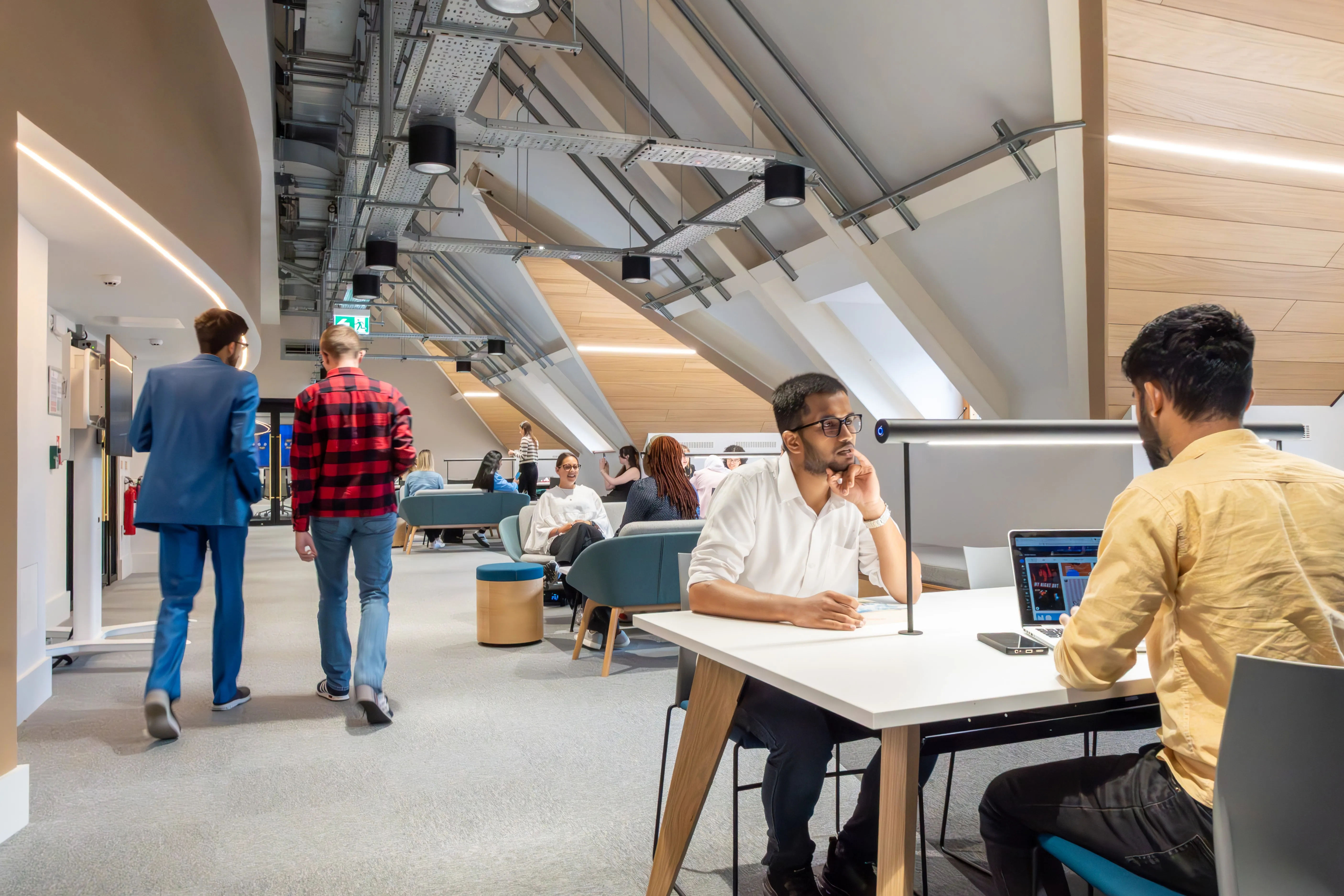 Students and staff in the Leeds City Campus social space.