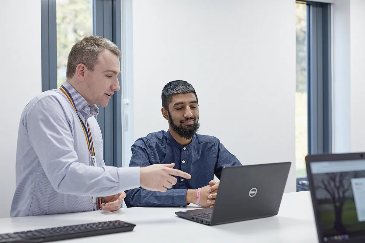 Student having a conversation with a member of Leeds Trinity's apprenticeship team..
