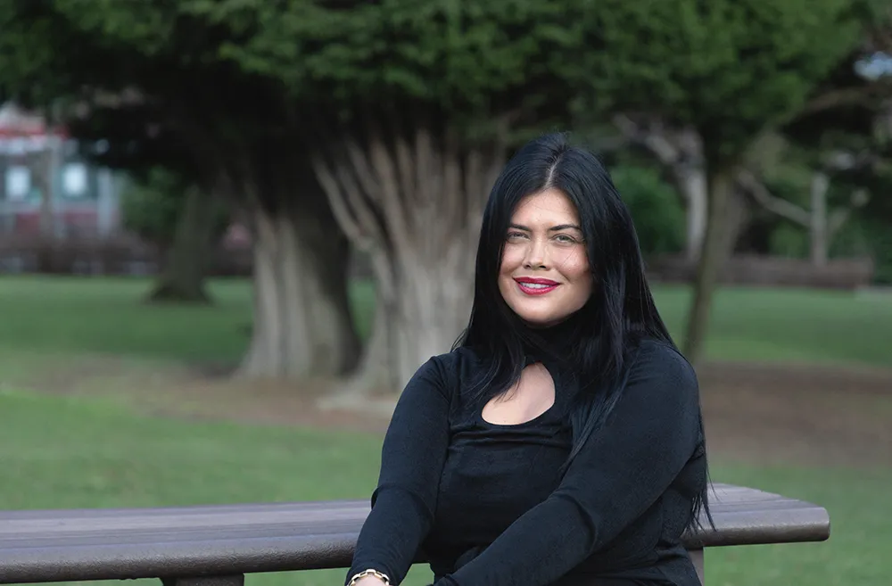 Criminology student sits outside Main Campus.