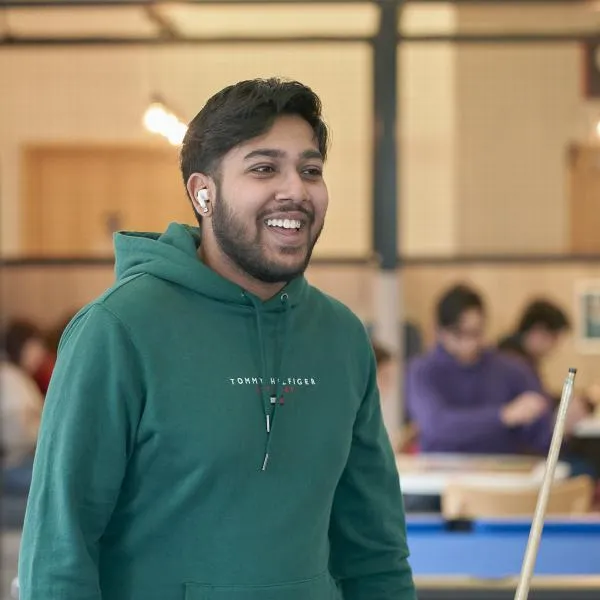 Student playing pool at LTSU Trini-tea Central..