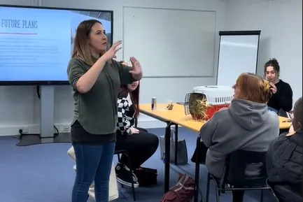 Image of alumna Becca Haigh speaking to CYPF students..