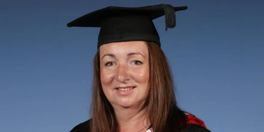 Female graduate in graduation hat.