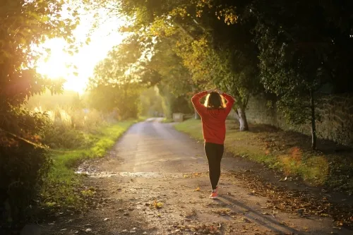 Woman walking along a country path.