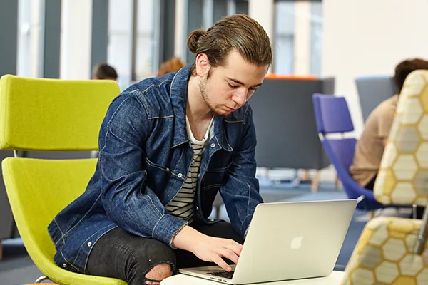 Student studying in a social space.