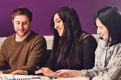 Psychology students work together in a study room.