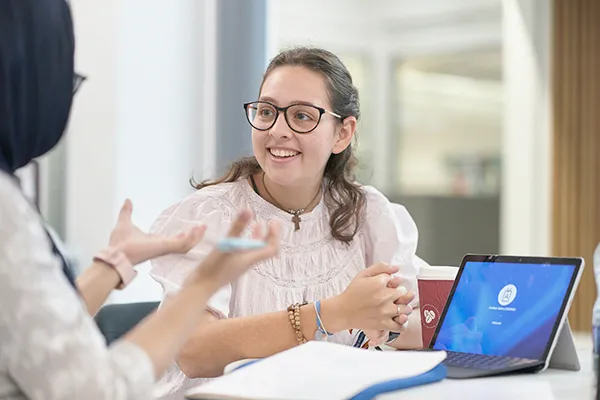 Student receiving advice or support from tutor.