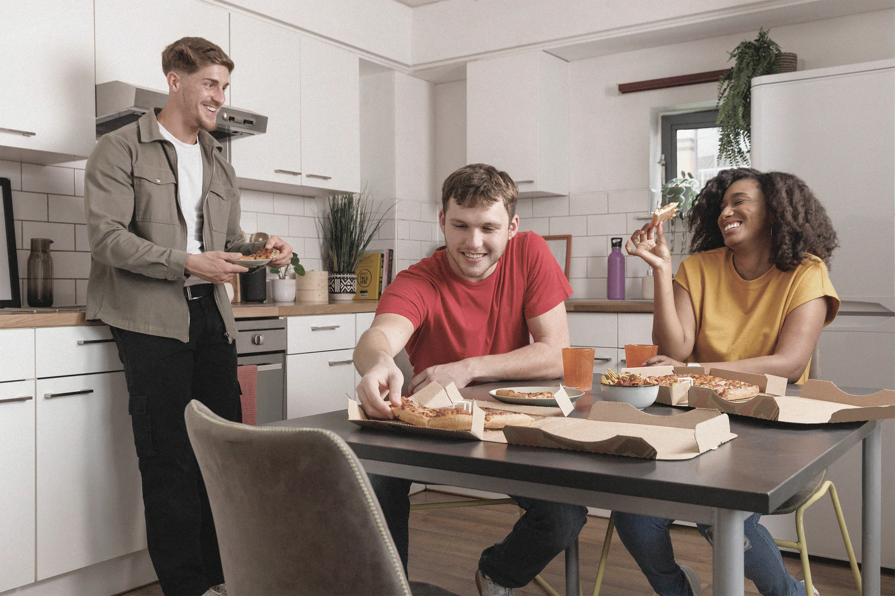 Students eating in shared kitchen at Clarence Dock Village.