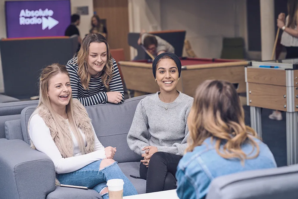 Students talking in Fountains Court common room.
