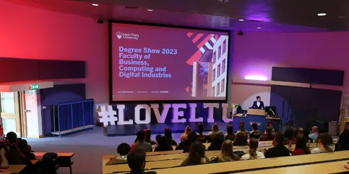 Auditorium filled with guests at event opening