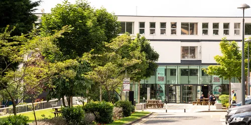 Front of Leeds Trinity building with trees to the left