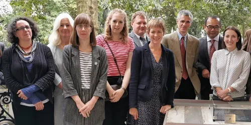 A group shot of researchers next to a table