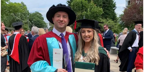 Lecturer and student celebrating graduation