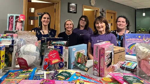 Staff from Leeds Trinity University, Leeds Children's Charity, and Bradford Baby Bank with presents donated during the Little Stars appeal