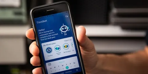Hand holding mobile phone with blue app homepage 
