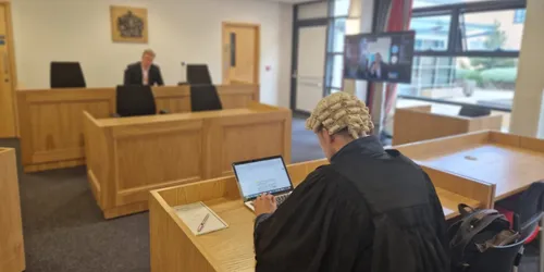 A Leeds Trinity student sits in front of a judge during a mooting competition