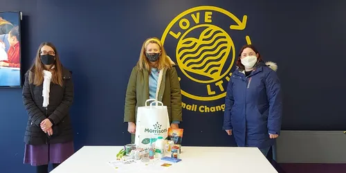 Three women in masks with package
