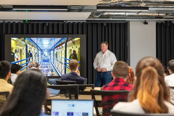Criminology academic giving lecture to students in lecture theatre at Leeds City Campus